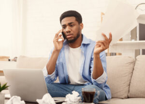 Black man, a patient advocate speaking on the phone.